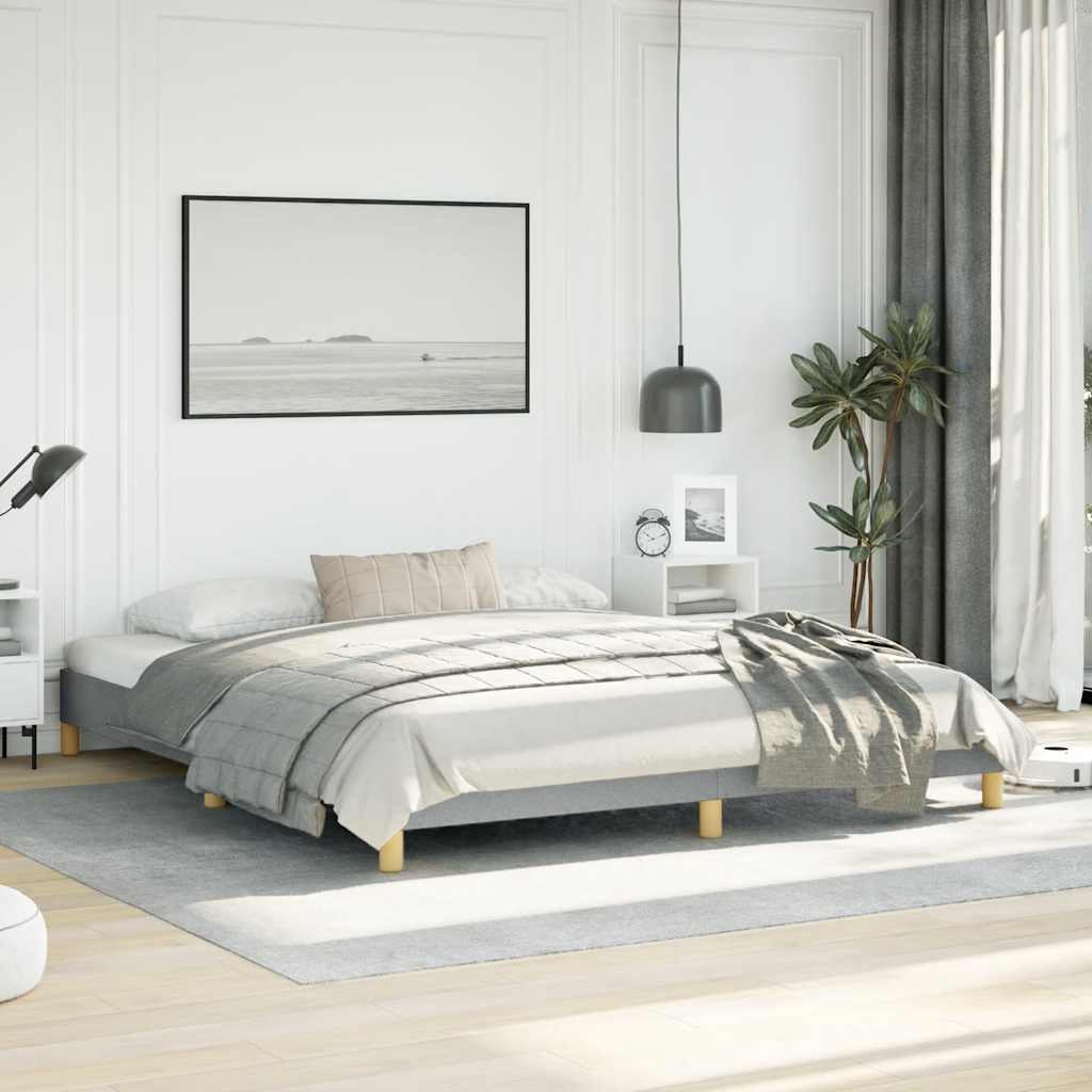 Gray upholstered platform bed frame with wooden slats and golden wood legs