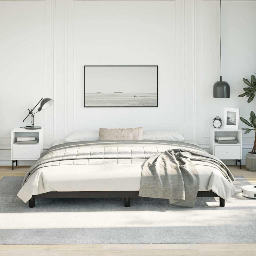 Modern black metal platform bed frame with white bedding and grey throw blanket