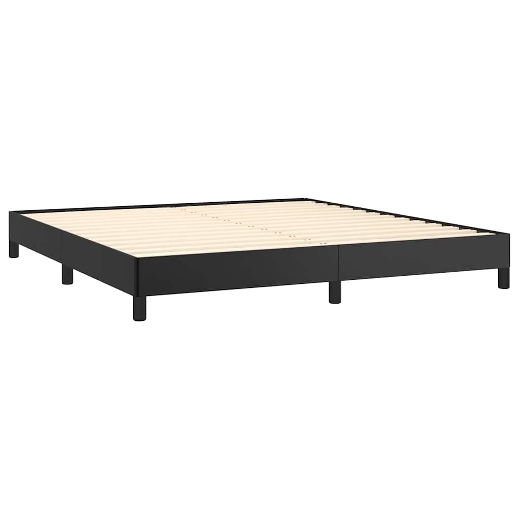 Black metal platform bed frame with white mattress and grey bedding