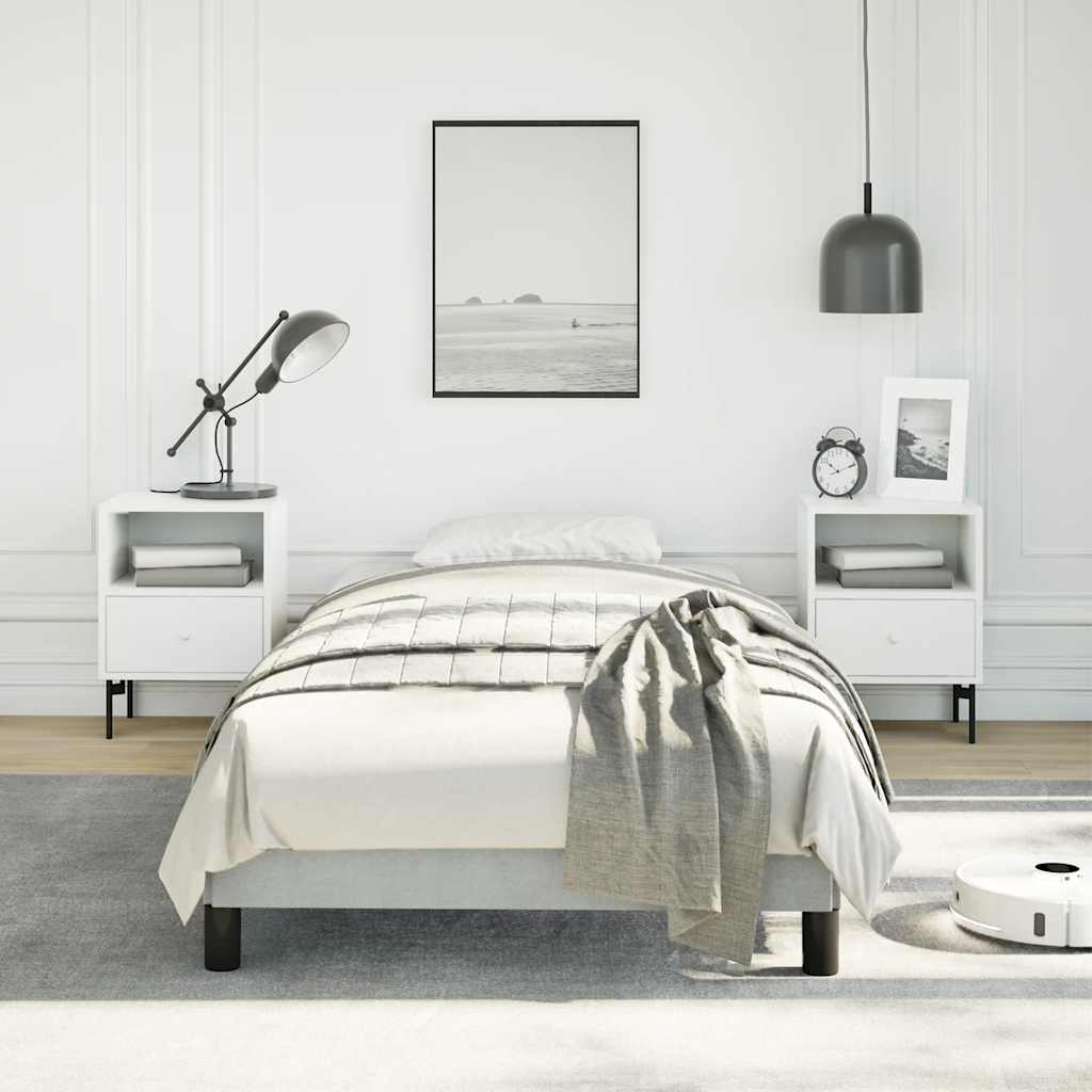 Grey upholstered single bed frame with wooden slats and black legs