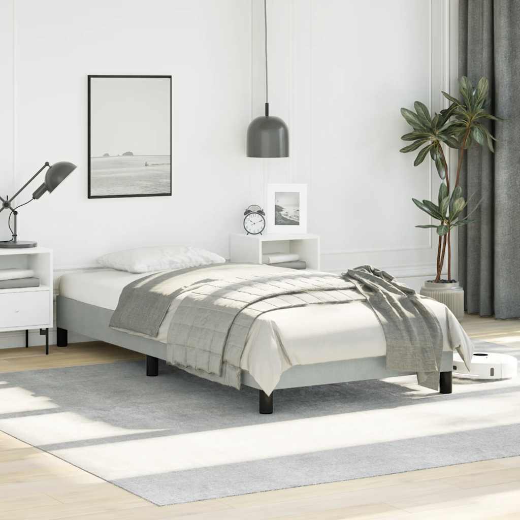 Modern white twin bed frame with gray comforter and throw blanket