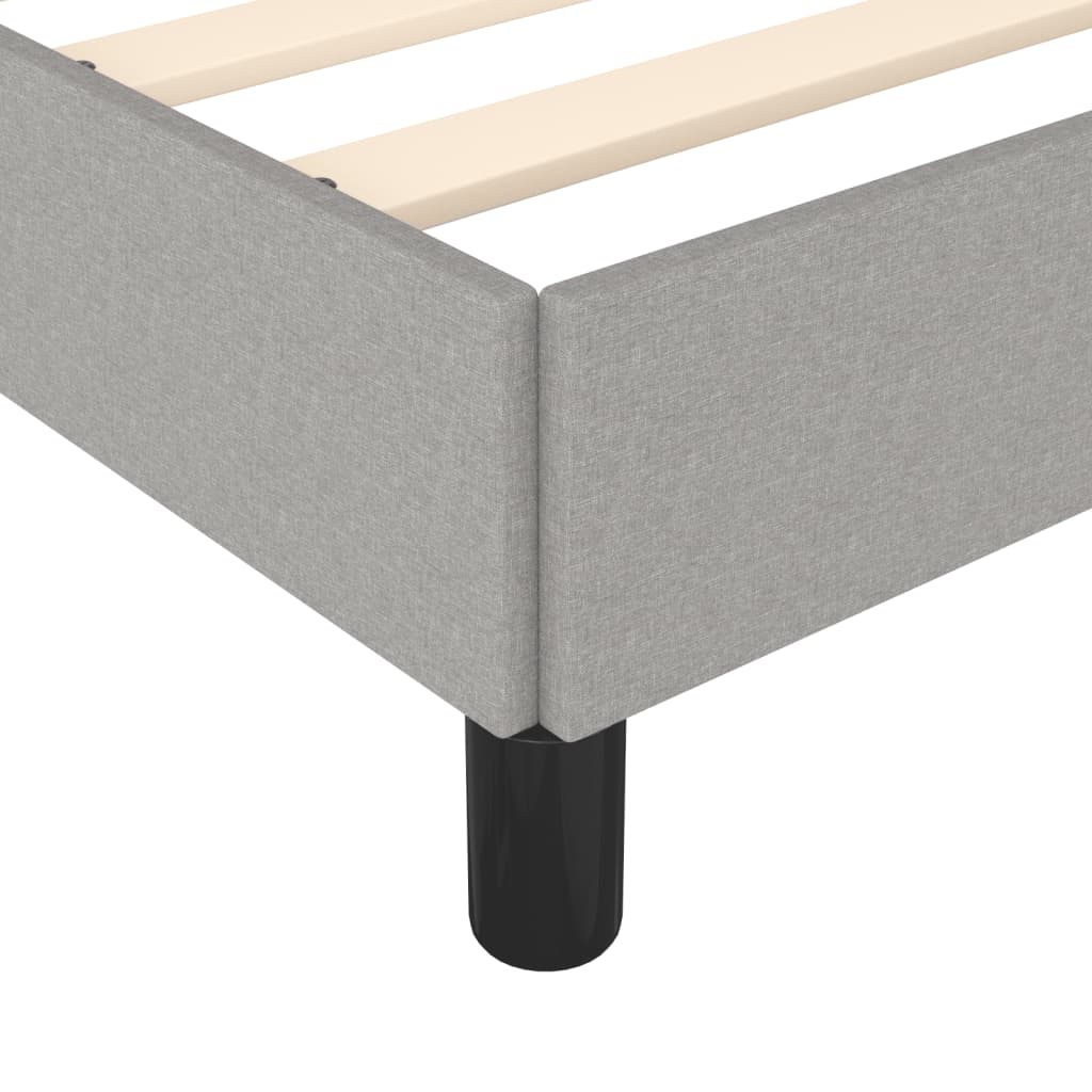 Grey fabric platform bed frame with wooden slats