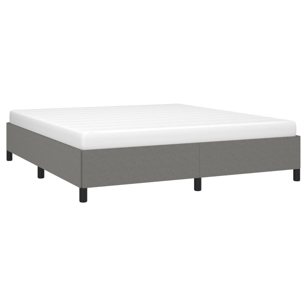 Grey upholstered bed frame with white mattress and black legs