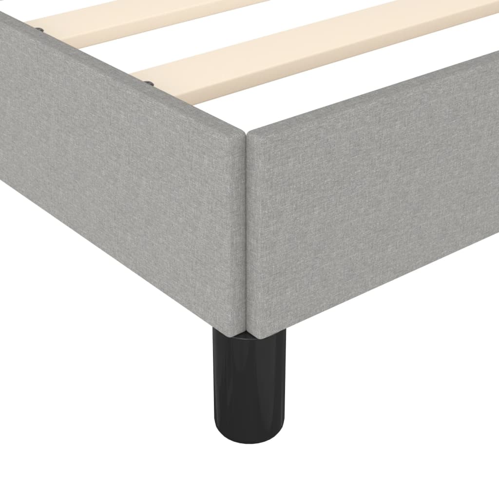 Grey fabric upholstered platform bed frame with wooden slats