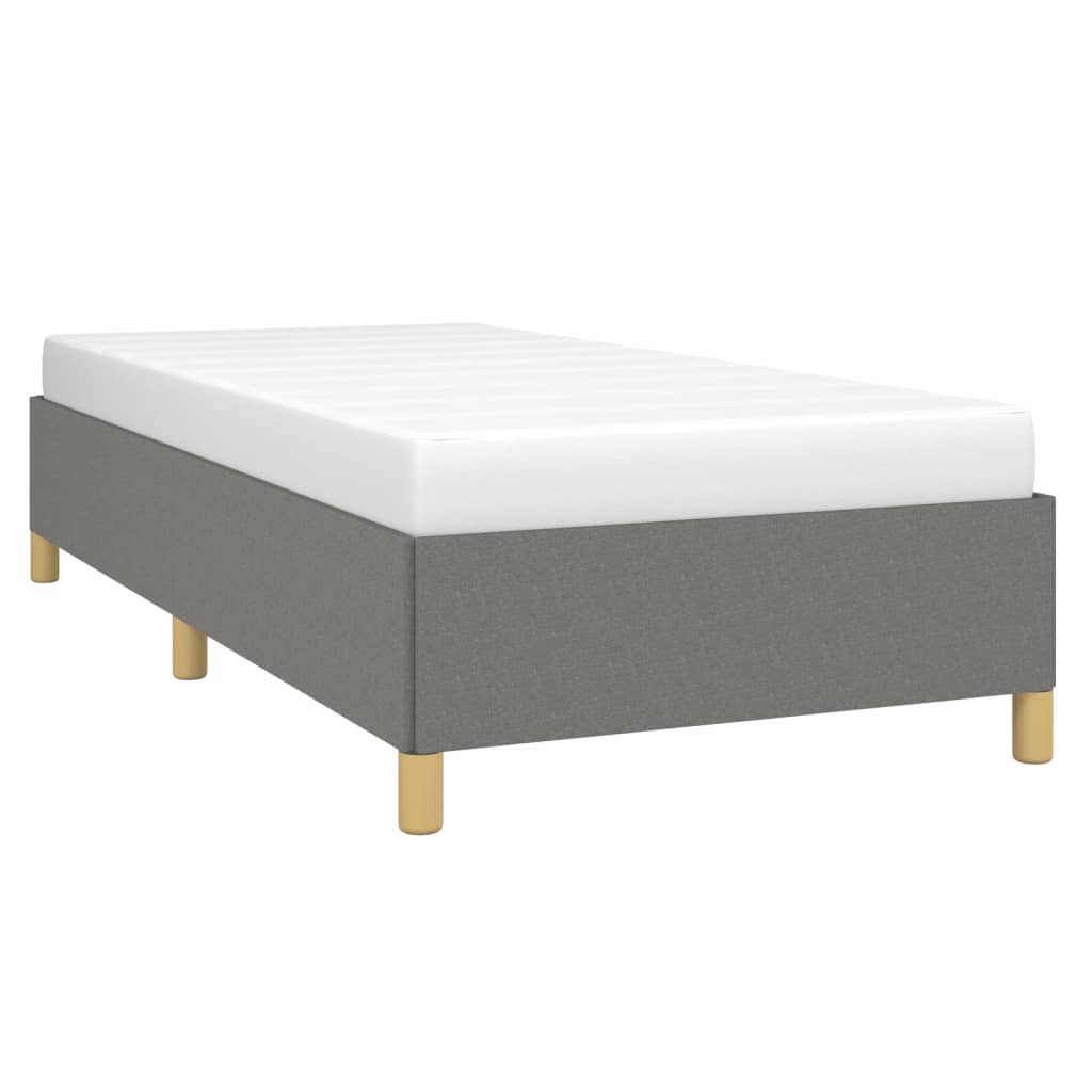 Grey fabric upholstered single bed frame with white mattress and gold legs