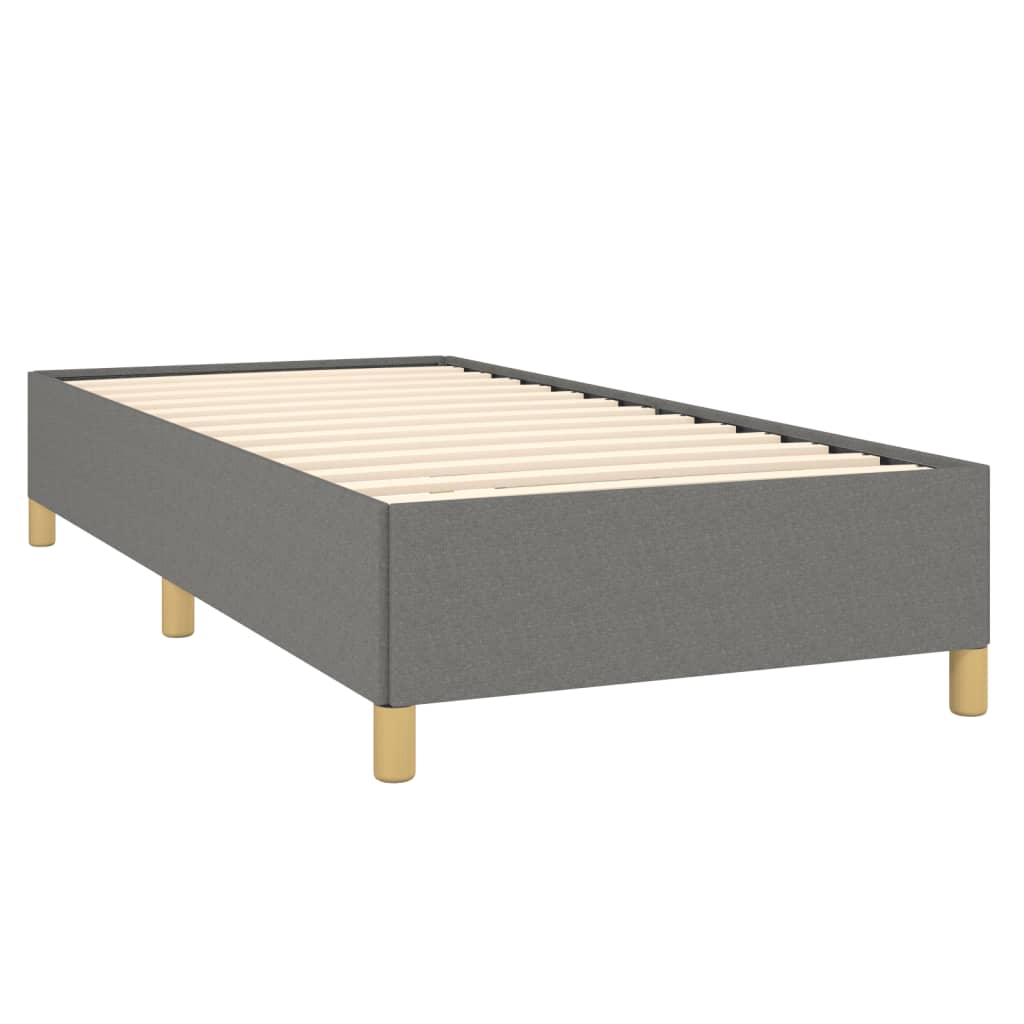 Gray upholstered twin bed frame with light wood legs