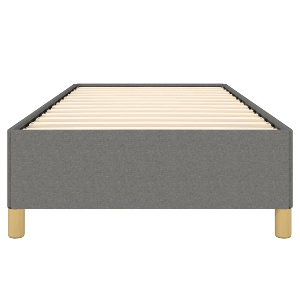 Grey upholstered single bed base with white mattress and wooden legs