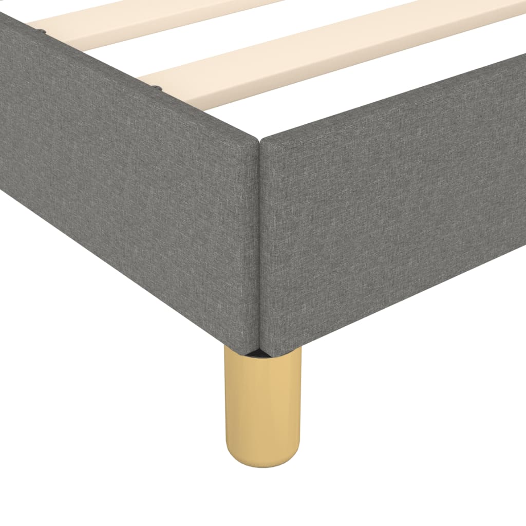 Grey fabric upholstered bed frame with wooden slats and tapered legs