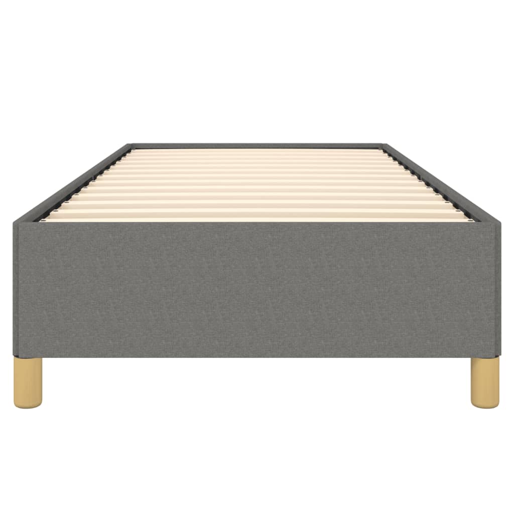 Gray upholstered single bed frame with white mattress and wooden legs