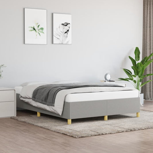Grey upholstered platform bed frame with wooden legs in a modern bedroom setting