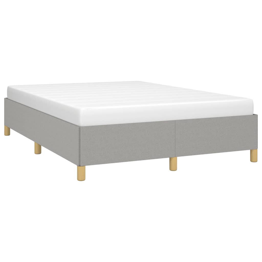 Light grey fabric divan bed frame with a white mattress and wooden legs