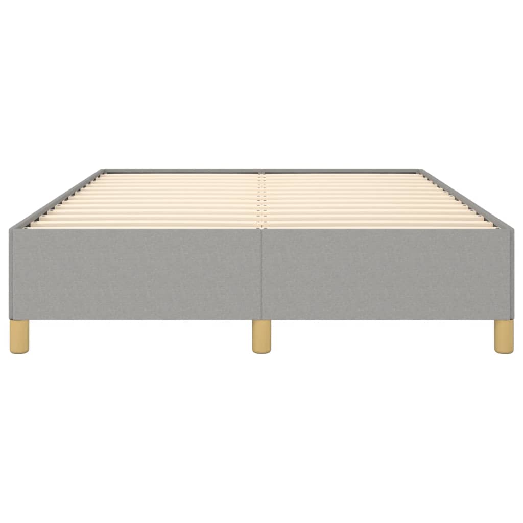 Grey upholstered bed frame with a white mattress and wooden legs