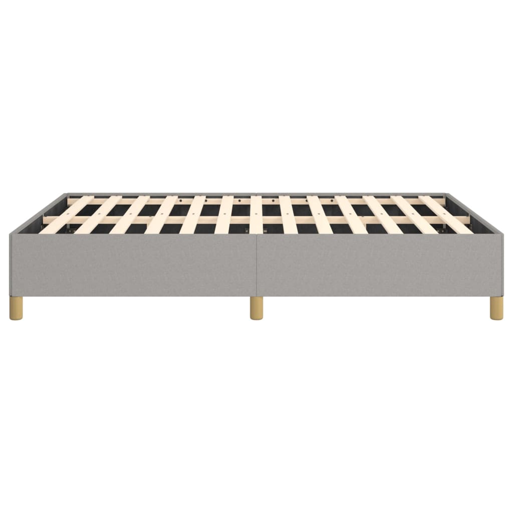 Upholstered grey bed frame with wooden slats and round legs