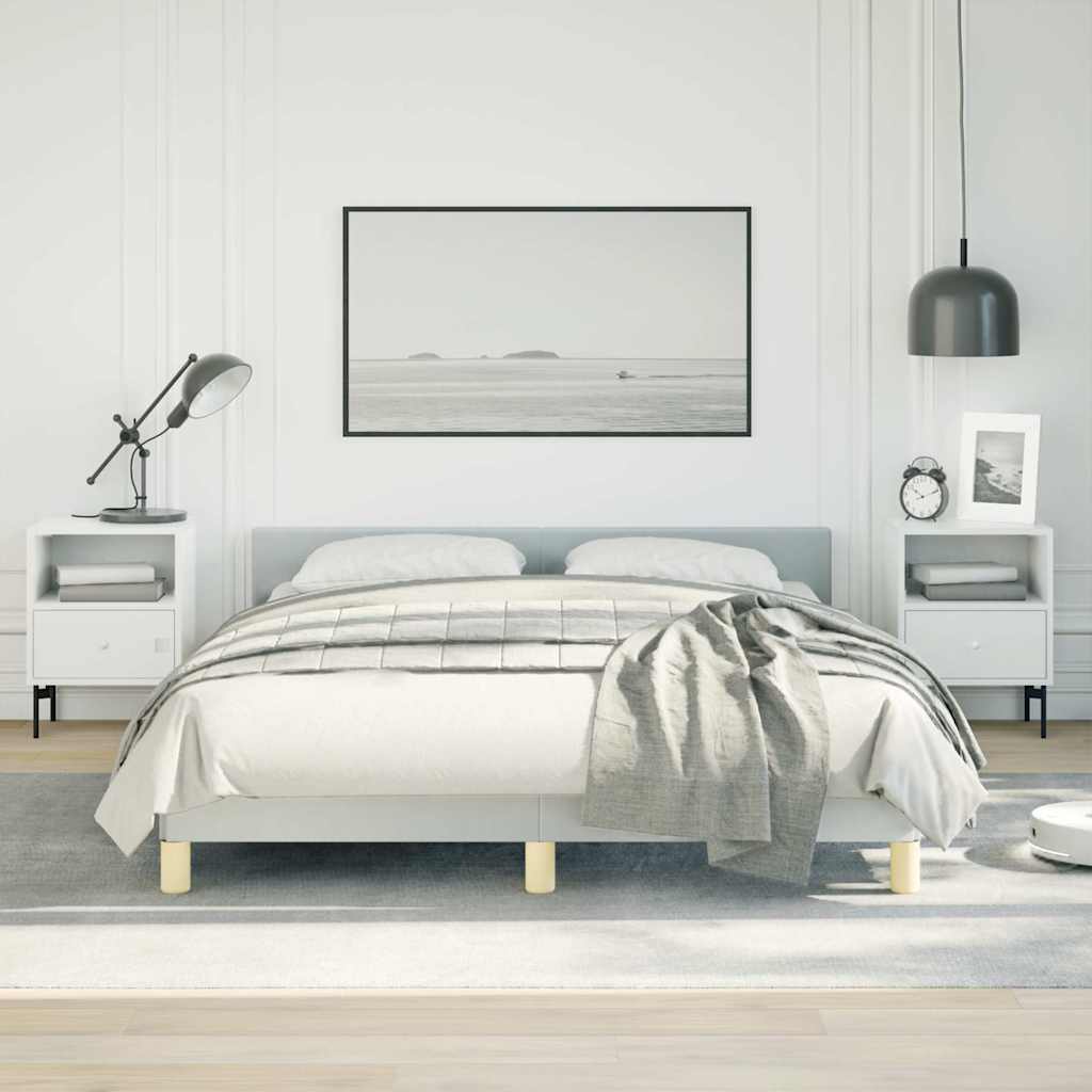 Modern upholstered grey queen bed frame with wooden legs and white linens