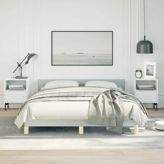 Modern upholstered grey queen bed frame with wooden legs and white linens