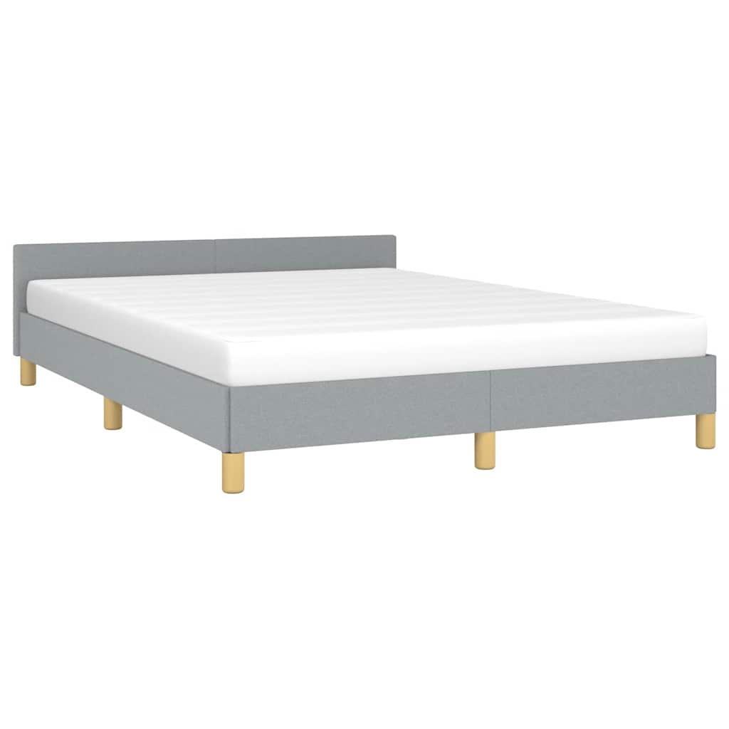 Upholstered grey bed frame with white mattress and wooden legs