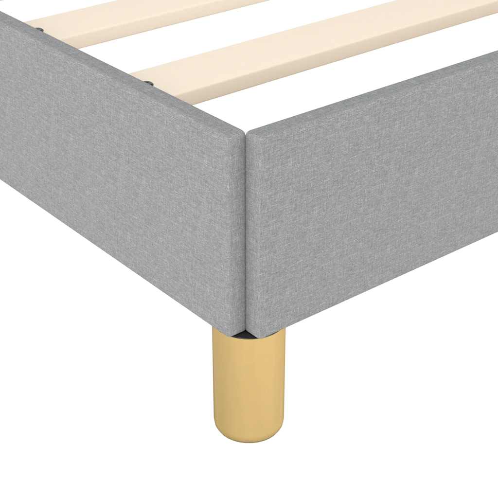 Grey upholstered bed frame with slatted base and gold legs