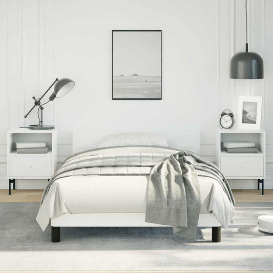 Minimalist white bed frame with a grey striped comforter and matching throw blanket