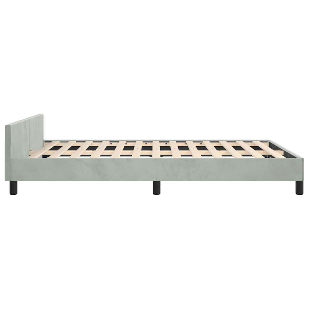Light grey upholstered bed frame with a simple headboard and wooden slats