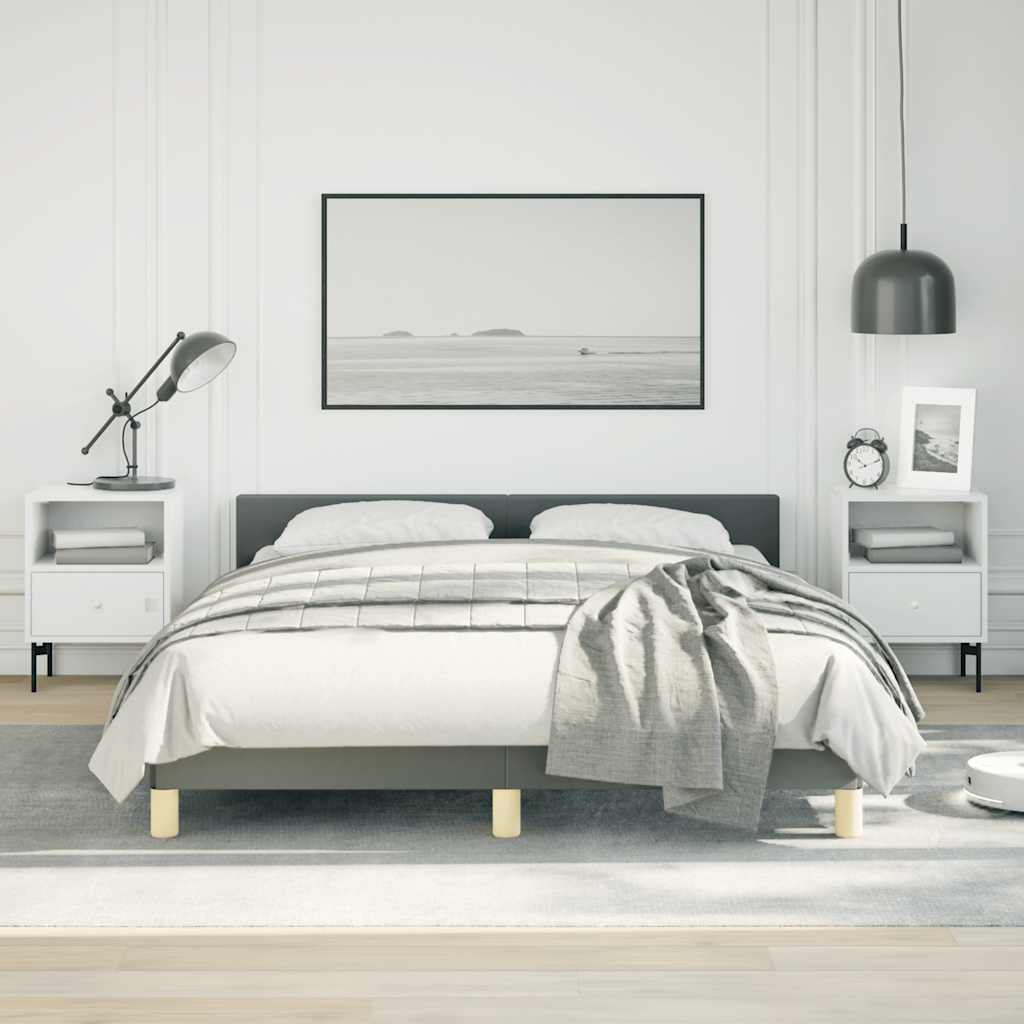 Modern grey upholstered platform bed with light wood legs and white bedding