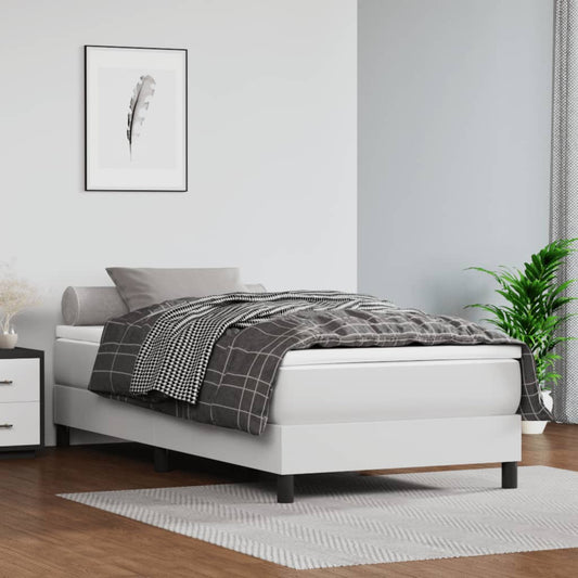 White upholstered bed frame with checkered duvet and grey pillows