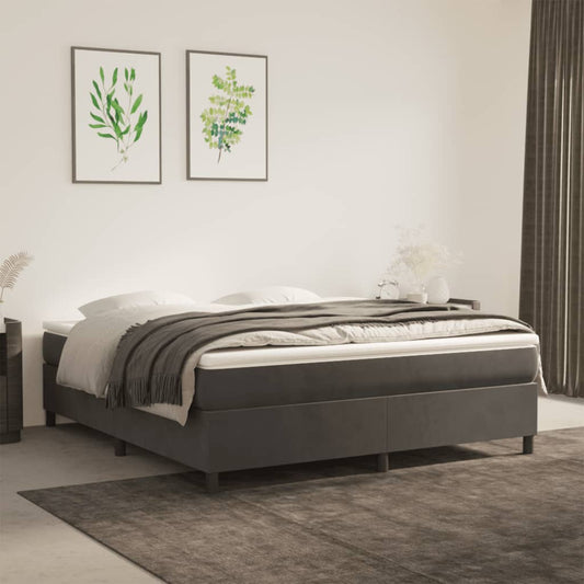 Dark gray upholstered divan bed with white mattress and charcoal throw
