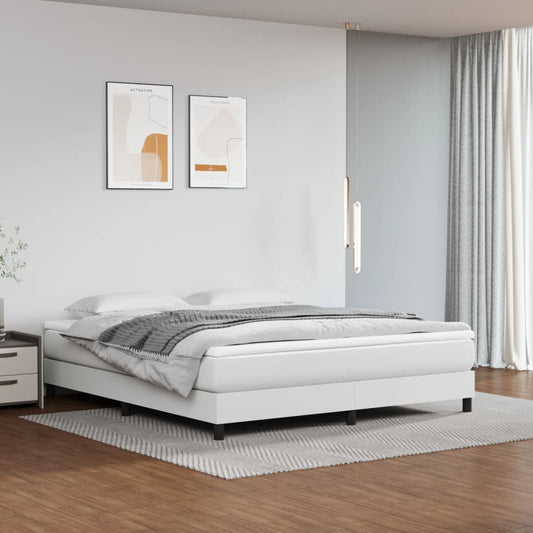 White upholstered platform bed with grey throw blanket