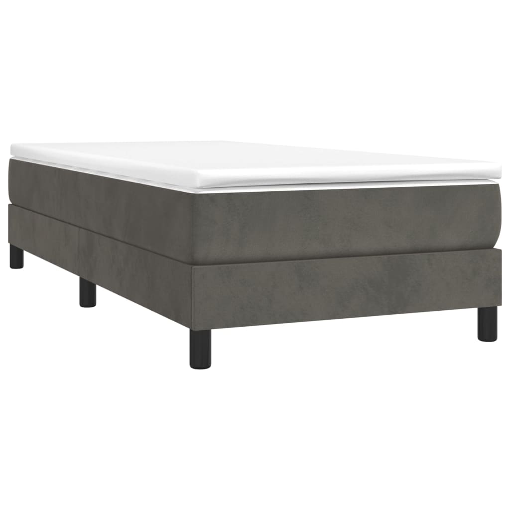 Grey upholstered twin bed frame with white mattress topper