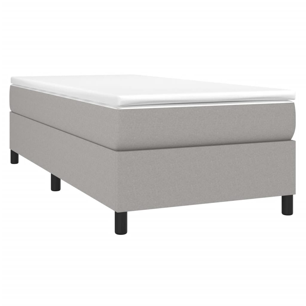 Modern grey fabric bed frame with white mattress topper and black legs