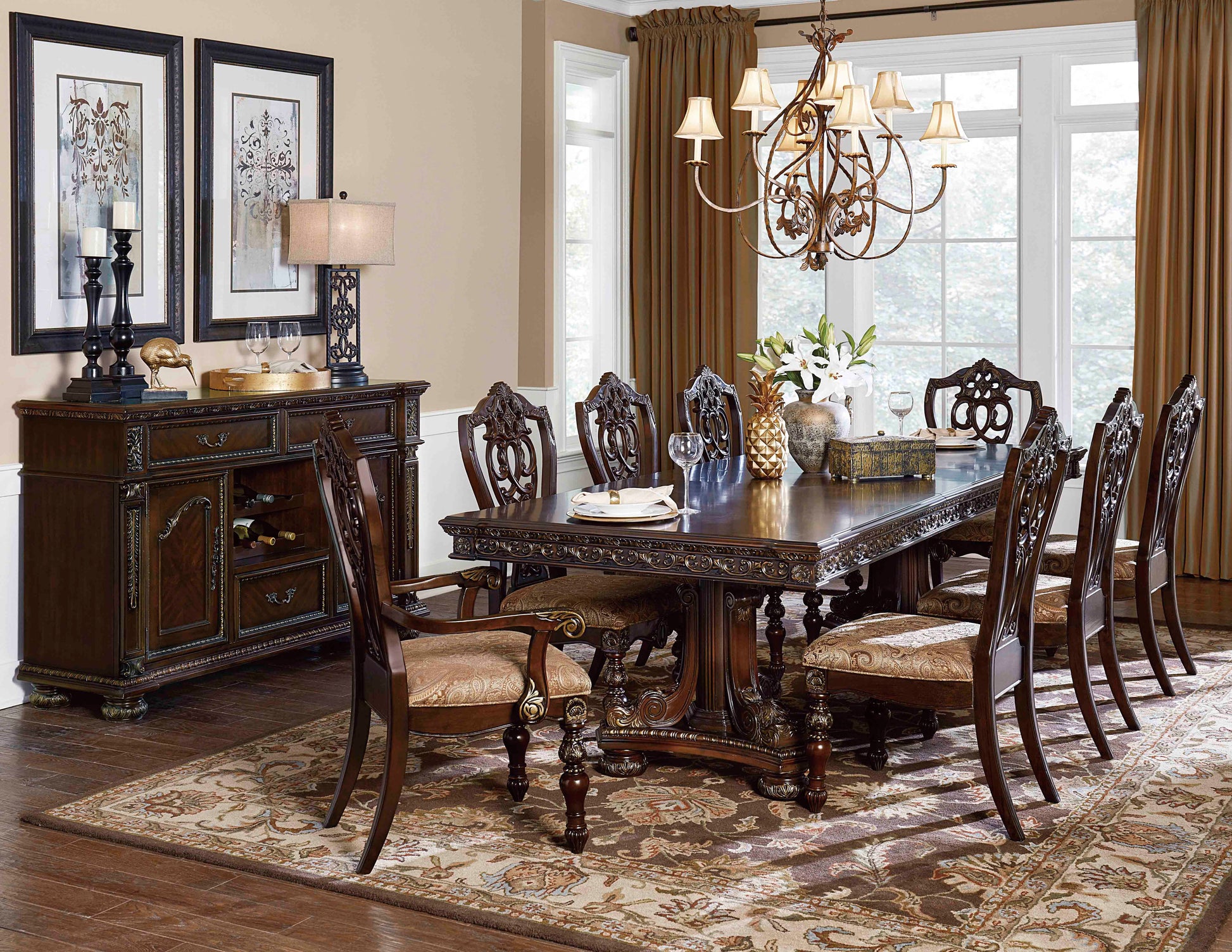 Ornate dark wood dining table with carved legs and detailed inlay