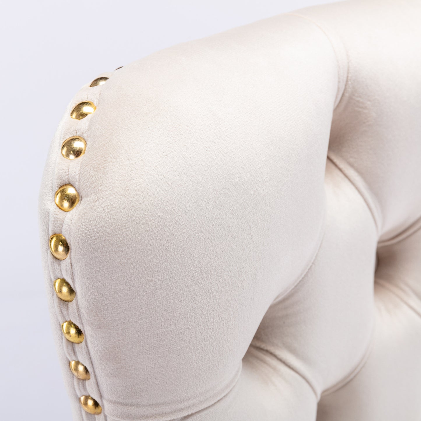 Cream velvet armchair with gold nailhead trim detail