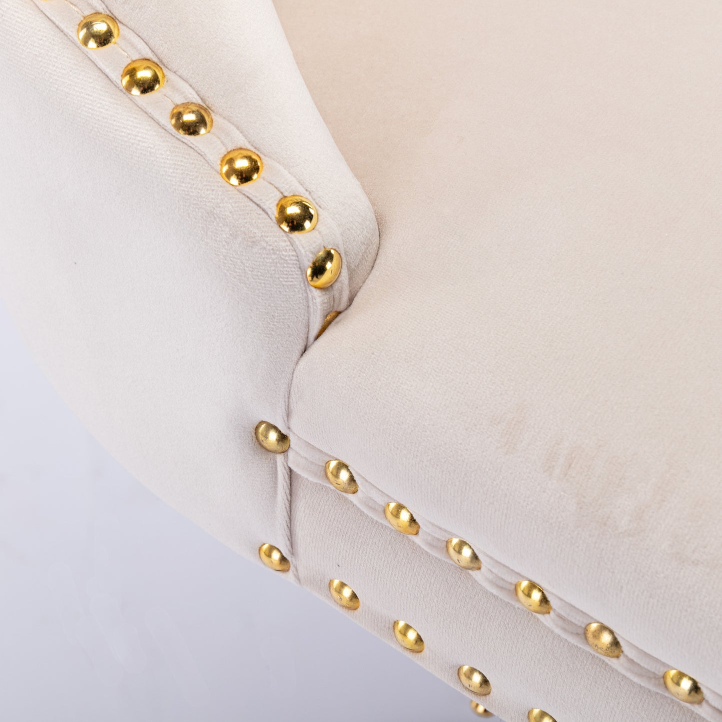 Cream velvet armchair with gold nailhead trim detail