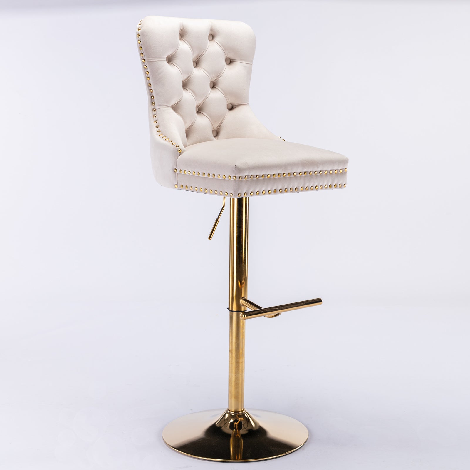 Cream velvet tufted bar stool with gold stud accents and brass base