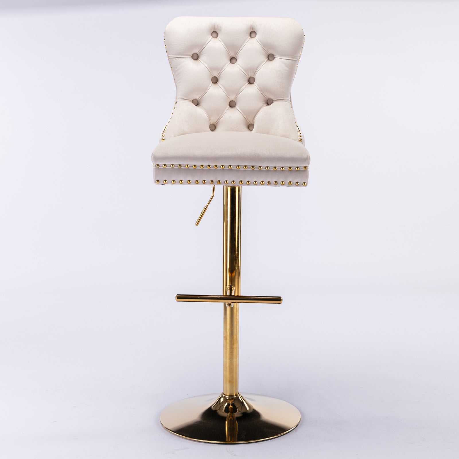 Tufted cream velvet bar stool with gold trim and adjustable brass pedestal