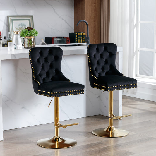 Black velvet tufted bar stool with gold studded trim and base