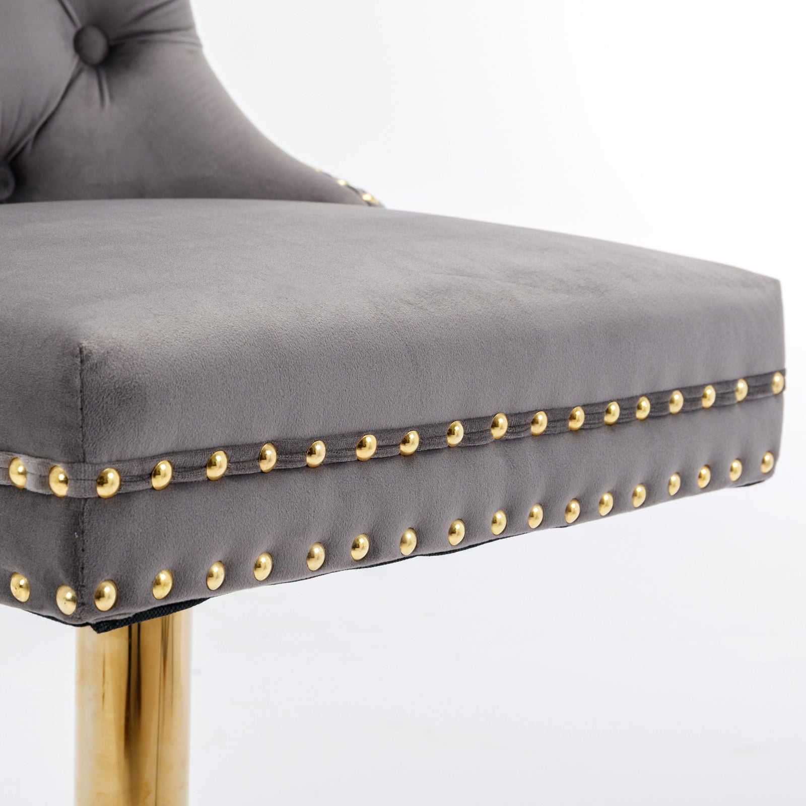Grey velvet bar stool with gold nailhead trim and chrome base