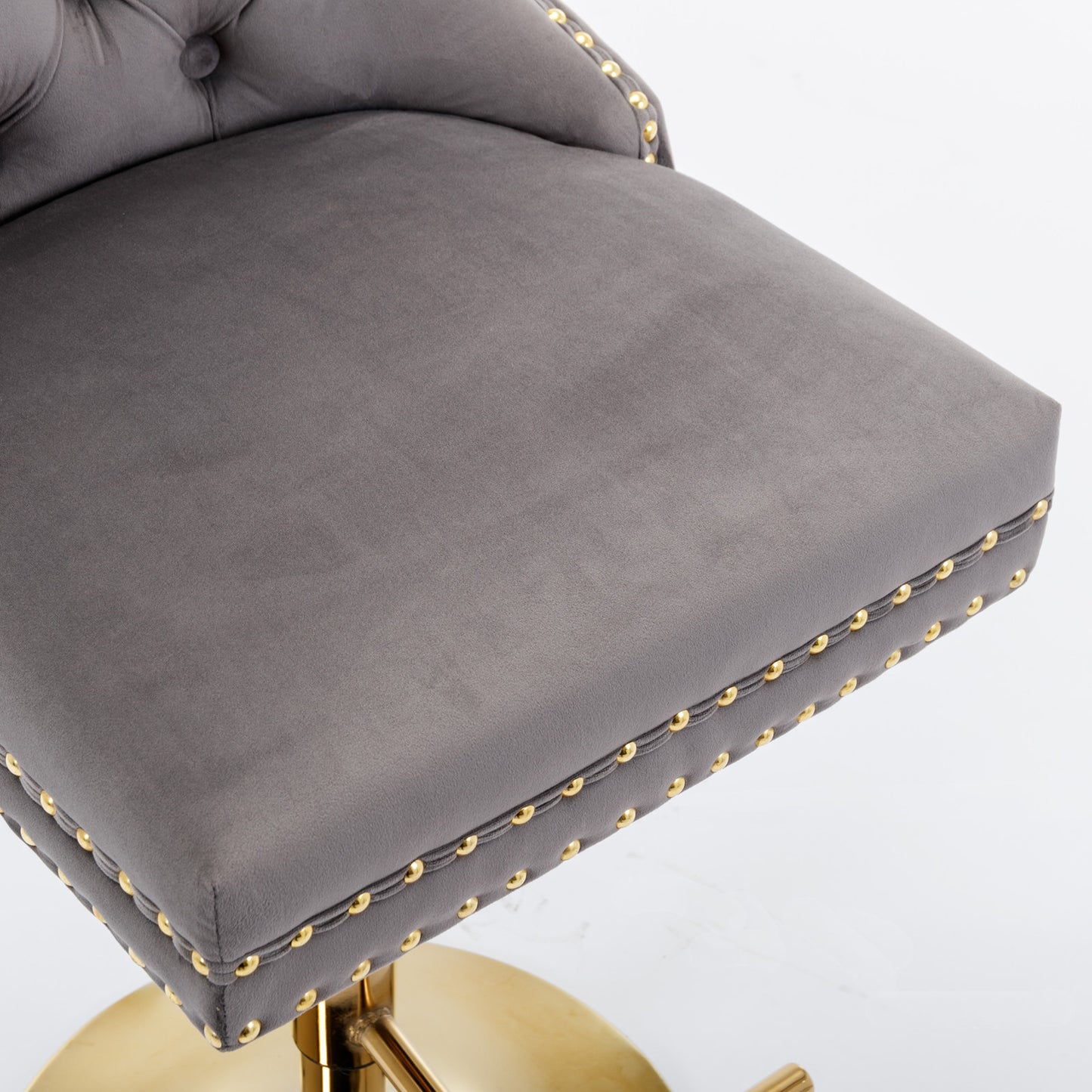 Grey velvet bar stool with gold studding and a gold base