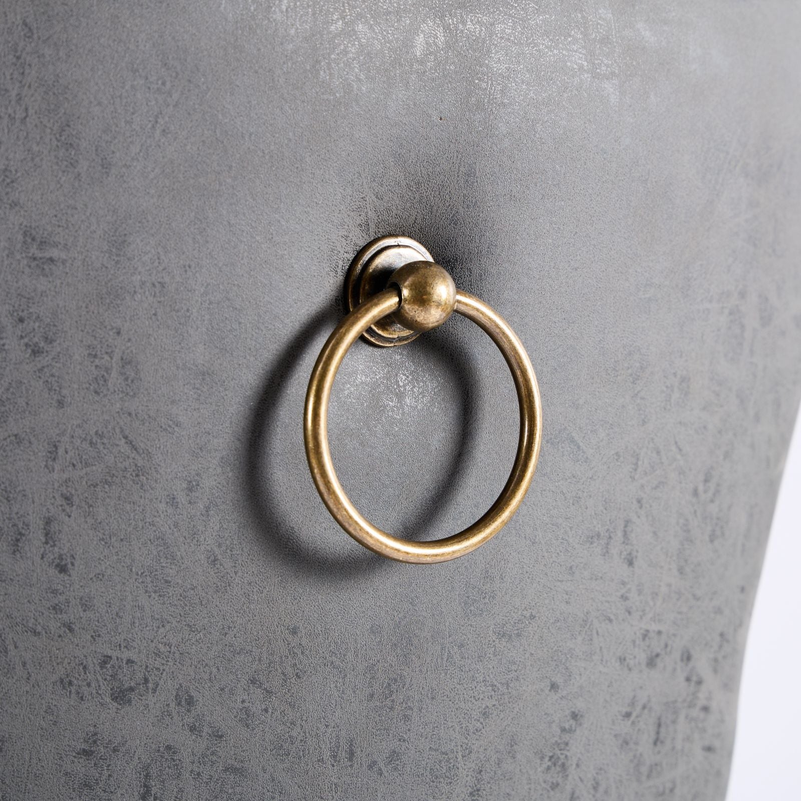 Grey faux leather dining chair with brass ring pull detail