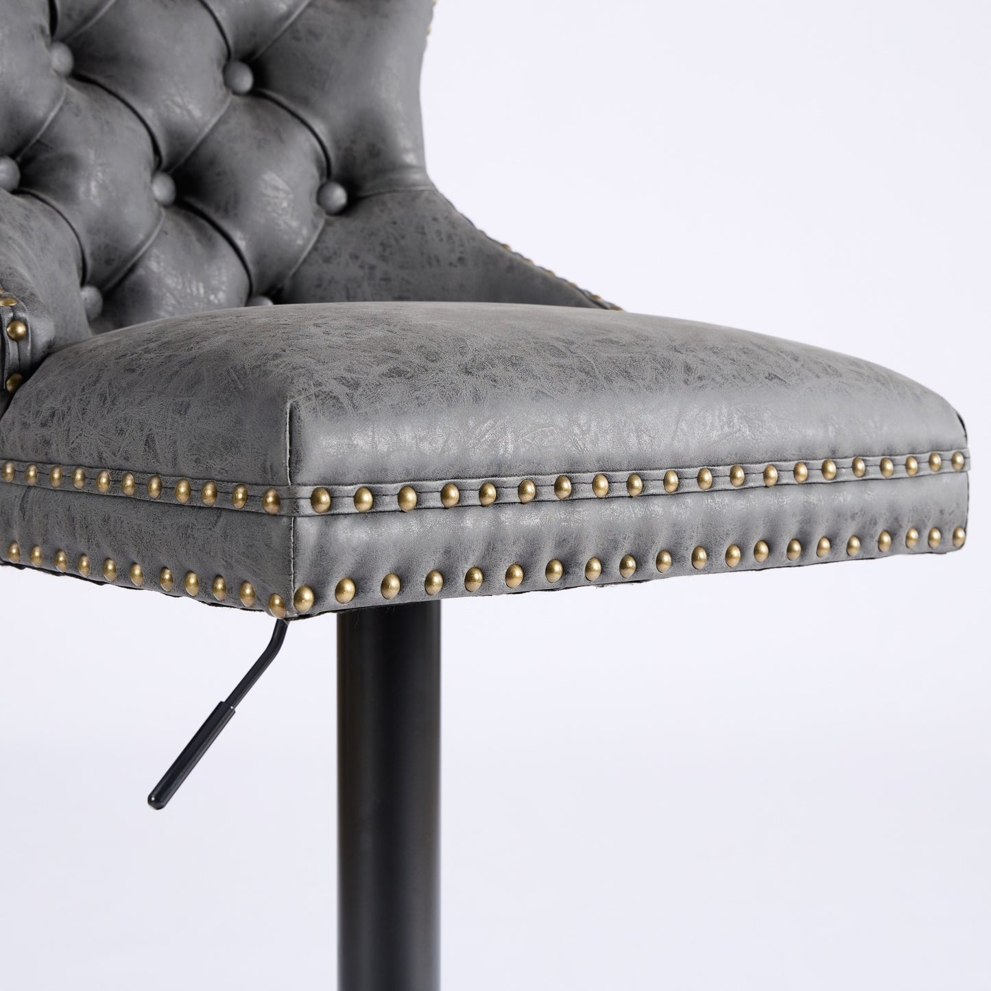 Grey faux leather tufted bar stool with brass nailhead trim