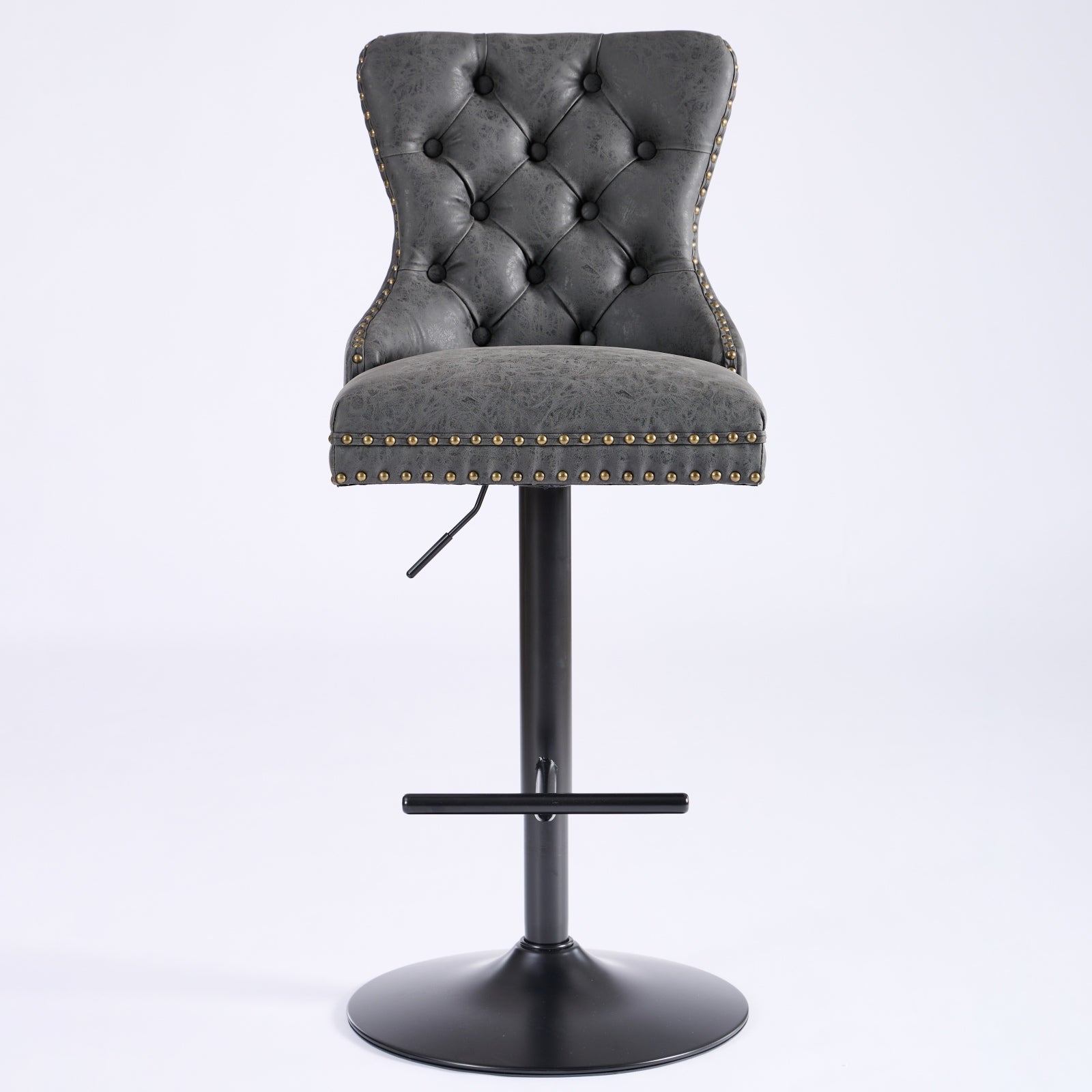 Tufted grey faux leather bar stool with brass nailhead trim and adjustable height