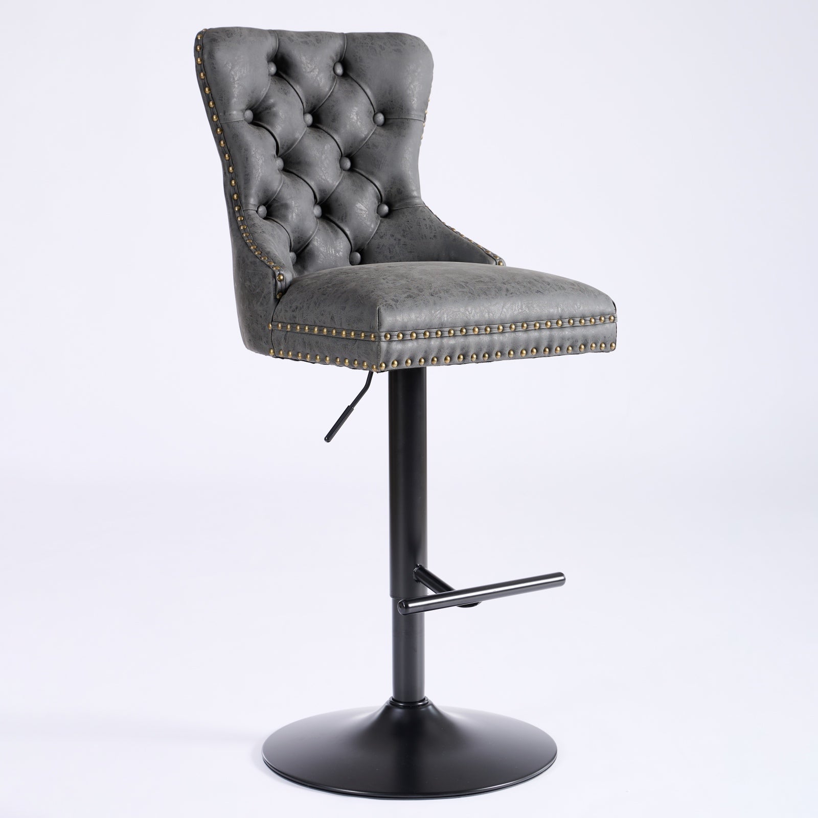 Tufted grey leatherette bar stool with antique brass nailhead trim and black metal base