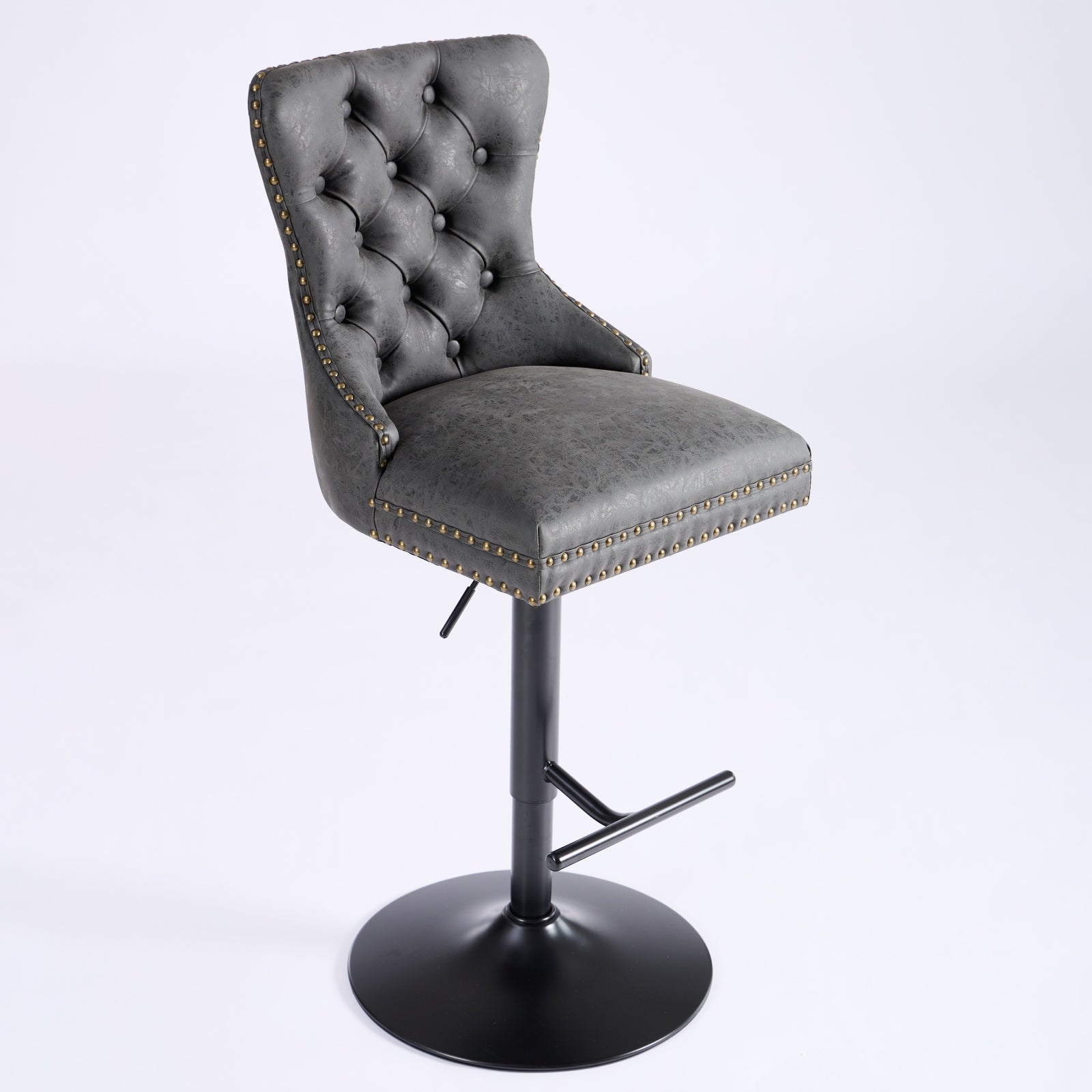Adjustable grey faux leather bar stool with diamond tufting and brass nailhead trim