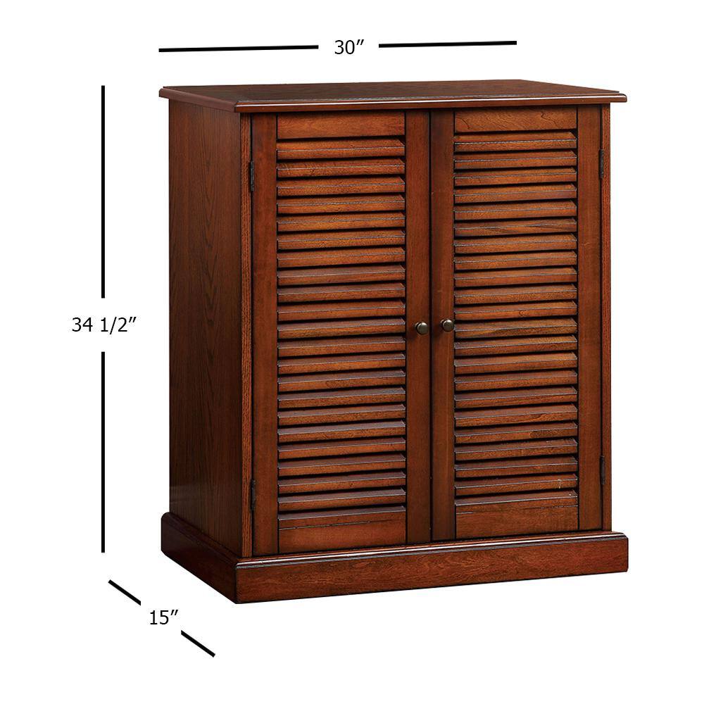 Brown wooden cabinet with louvered doors and brass knobs