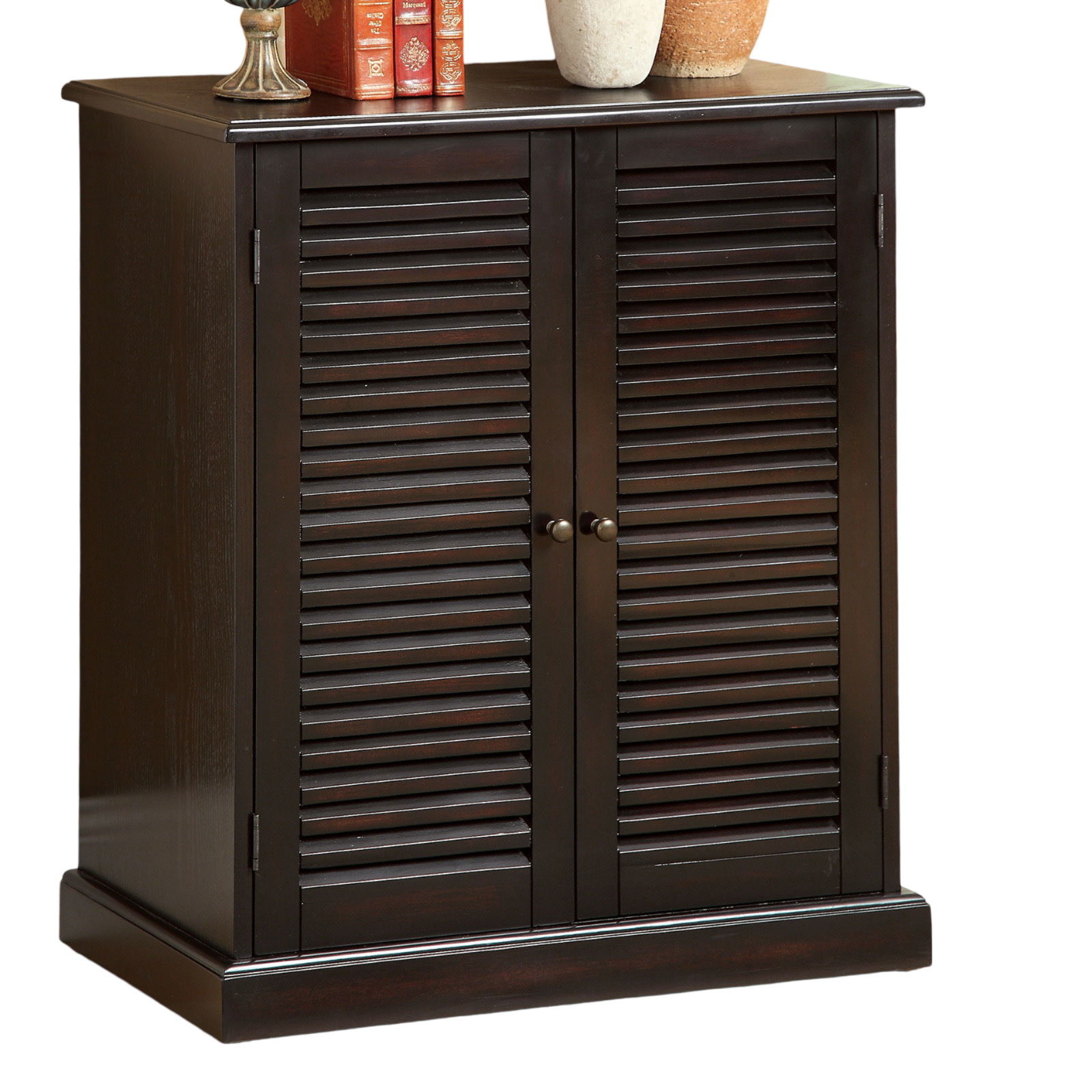 Dark wood storage cabinet with louvered doors and brass knobs
