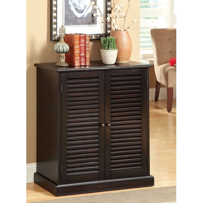 Dark wood slatted door accent cabinet with decorative knobs