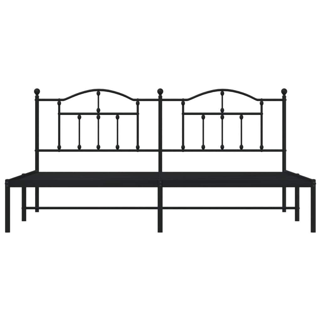Ornate bronze metal bed frame with a curved headboard and footboard
