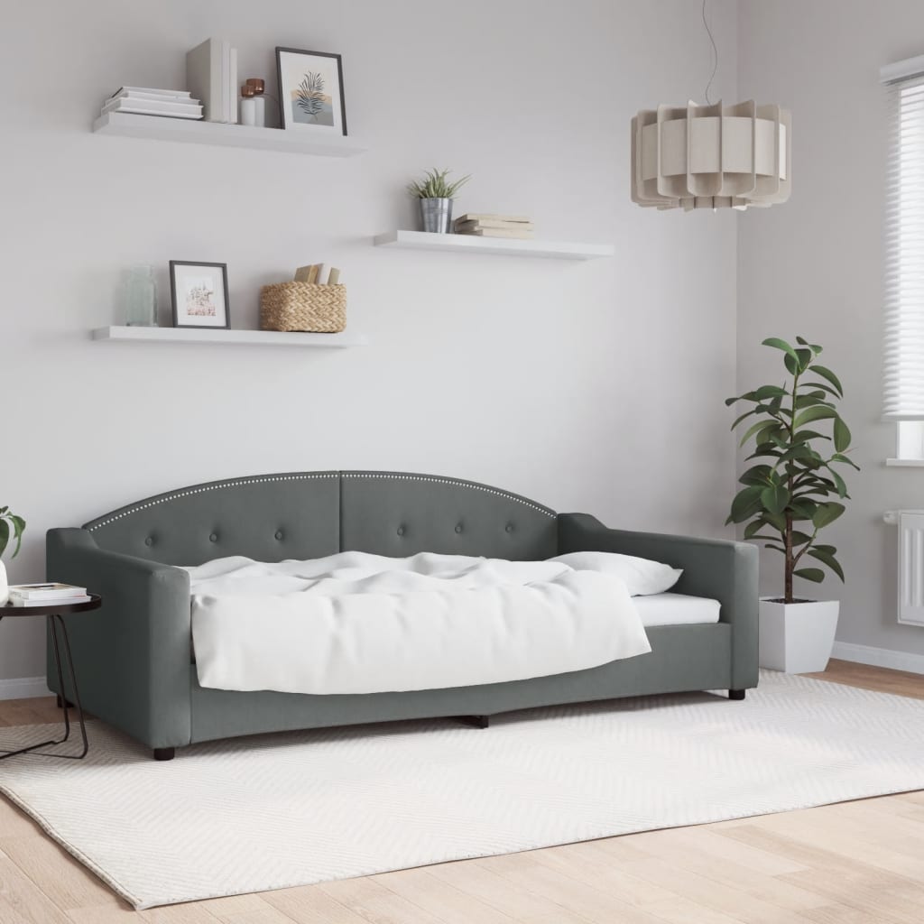 Tufted grey velvet daybed with studded trim and white bedding