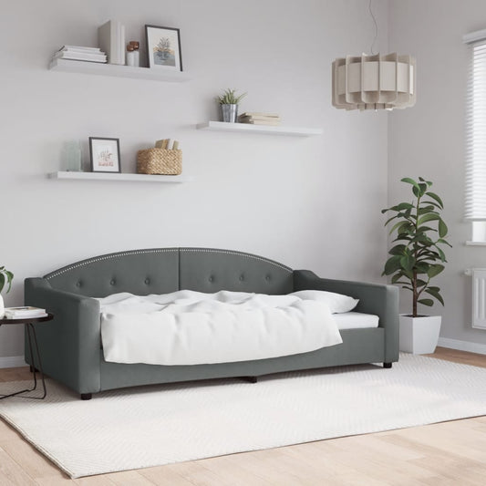 Tufted grey velvet daybed with studded trim and white bedding