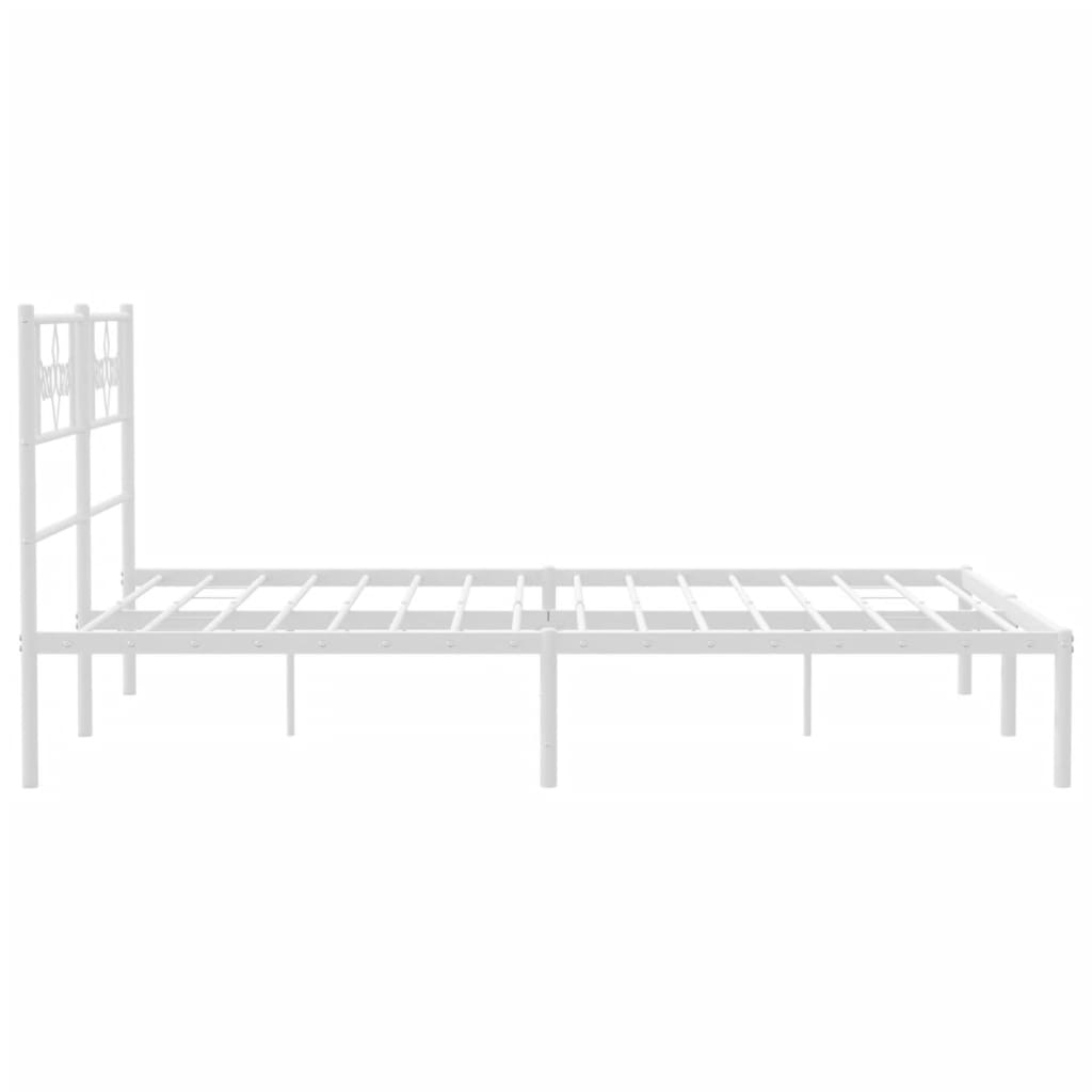White metal bed frame with decorative headboard and mattress