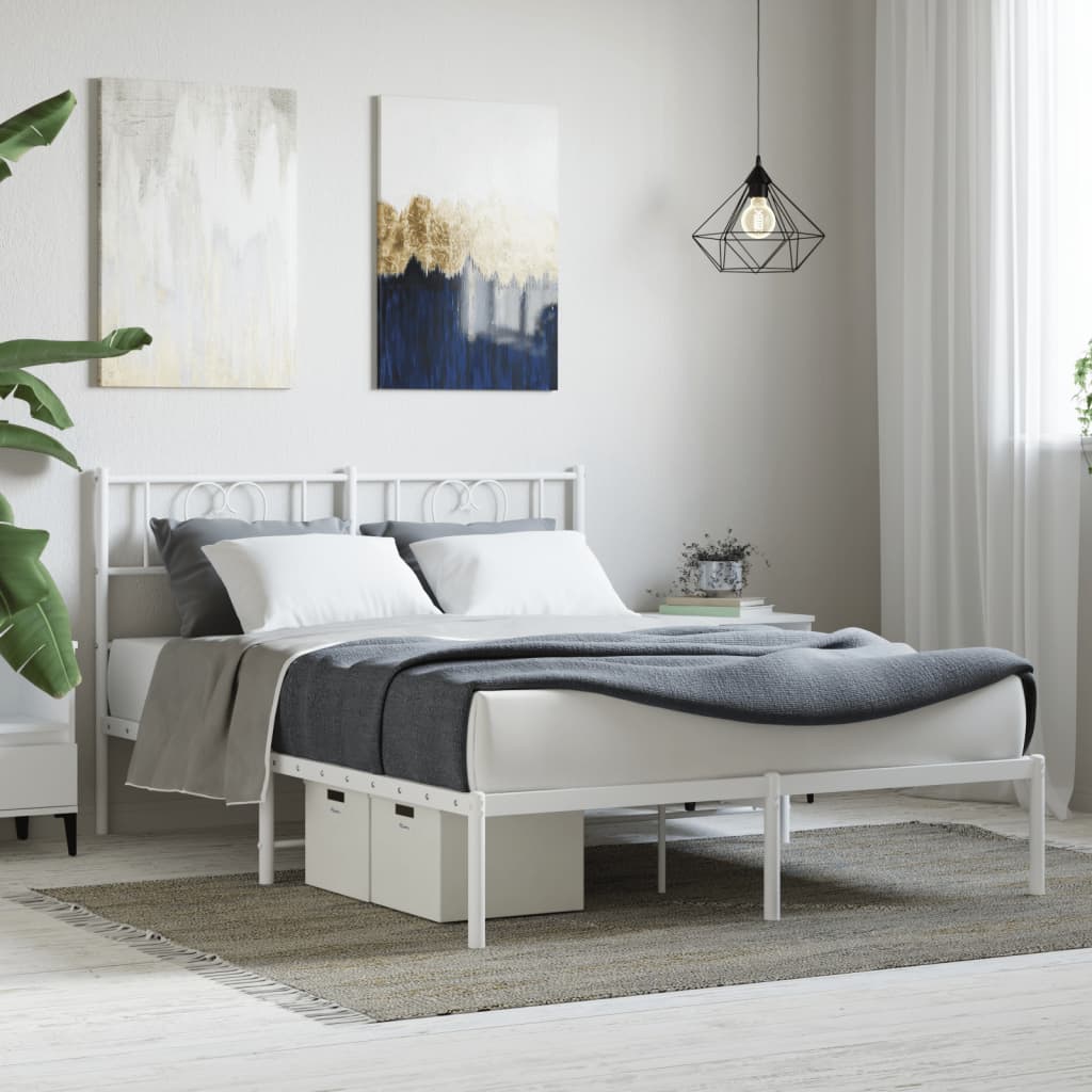 White metal twin bed frame with heart detailing on headboard